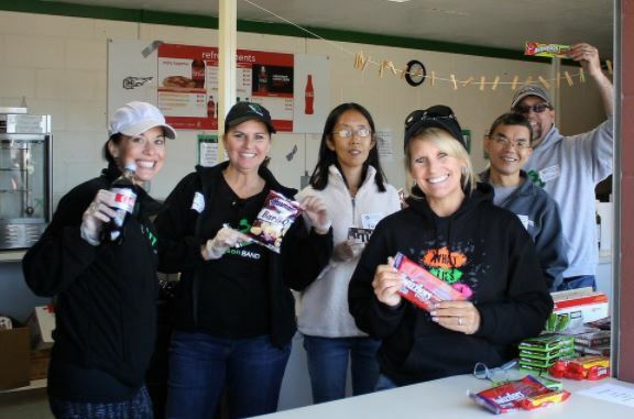 group smiling for photo holding snacks